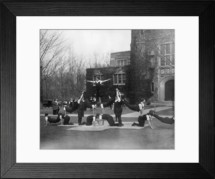 Framed Print : College students performing acrobatic activities