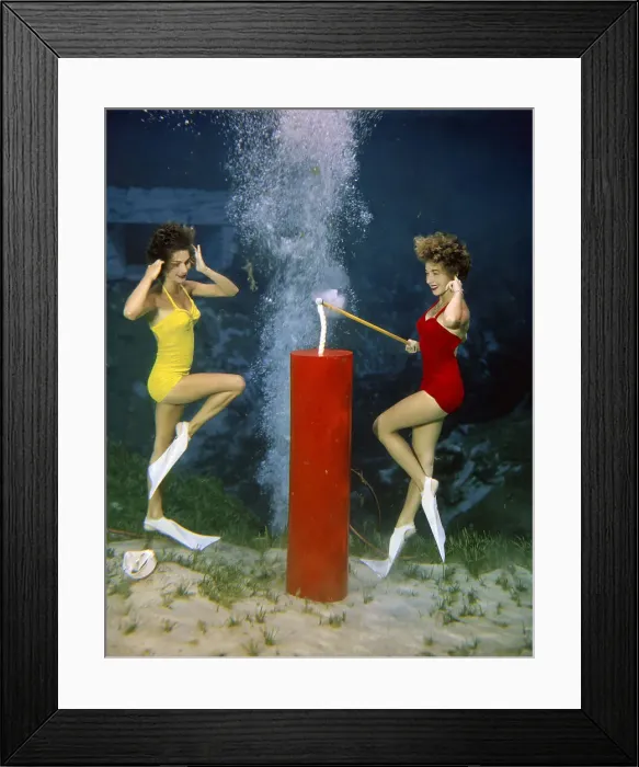 Framed Print : Women Lighting a Firecracker Underwater Framed Print : Women Lighting a Firecracker Underwater