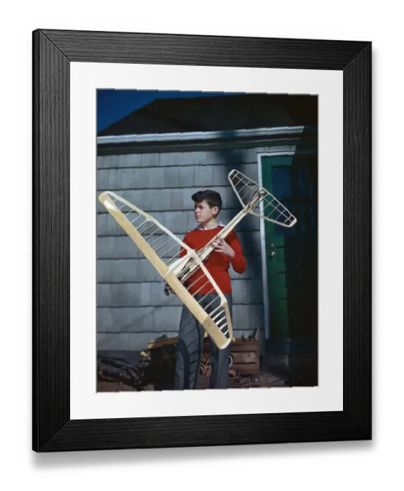 Framed Print : USA, New York State, Long Island, North Hempstead, Port Washington, Boy (10-12) holding model airplane