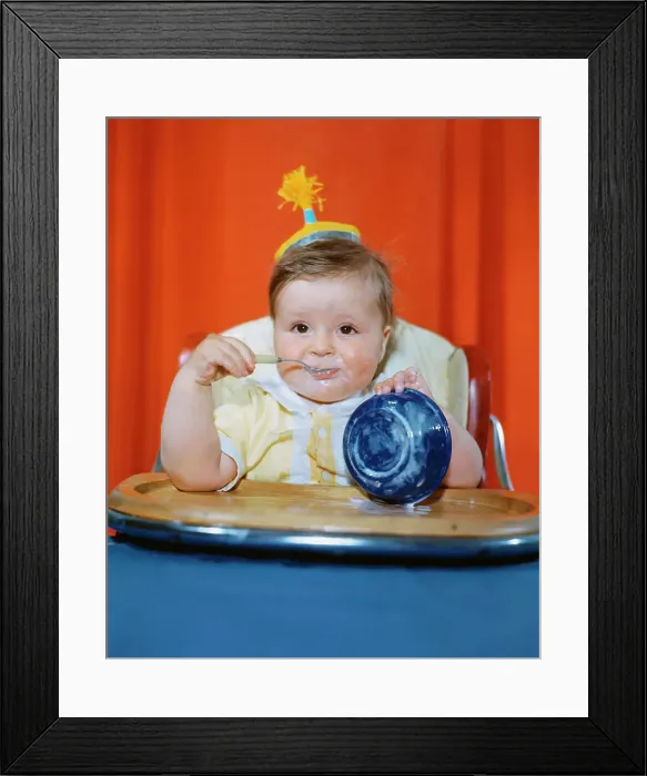 Framed Print : Baby Eating with Overturned Bowl Framed Print : Baby Eating with Overturned Bowl