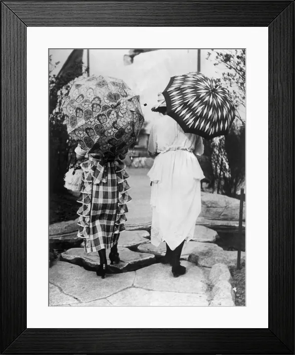 Framed Print : Women with umbrellas walking