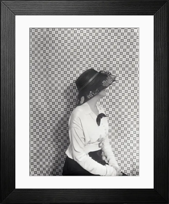 Framed Print : Vintage photograph of young trendy woman sitting against checked curtain Framed Print : Vintage photograph of young trendy woman sitting against checked curtain