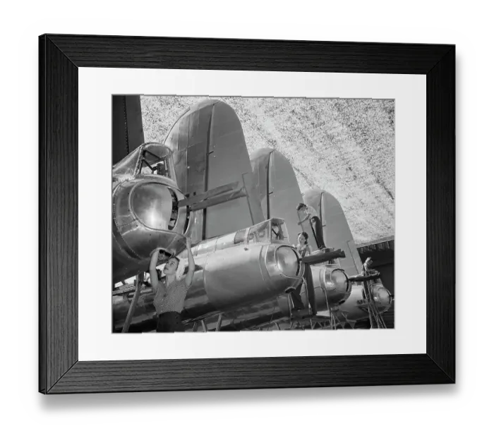 Framed Print : Young Woman Working on Airplane Part Framed Print : Young Woman Working on Airplane Part