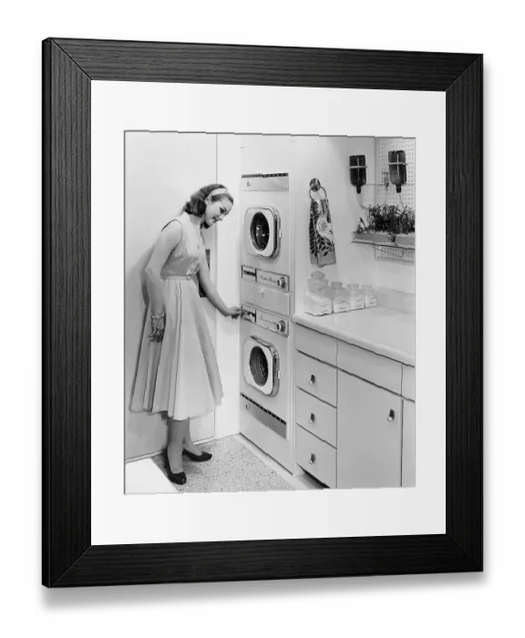 Framed Print : Woman Turning On A Washing Machine Framed Print : Woman Turning On A Washing Machine