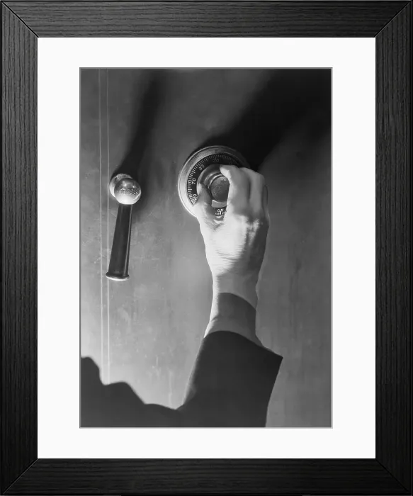 Framed Print : Close-Up Of Hand Opening Safe Framed Print : Close-Up Of Hand Opening Safe