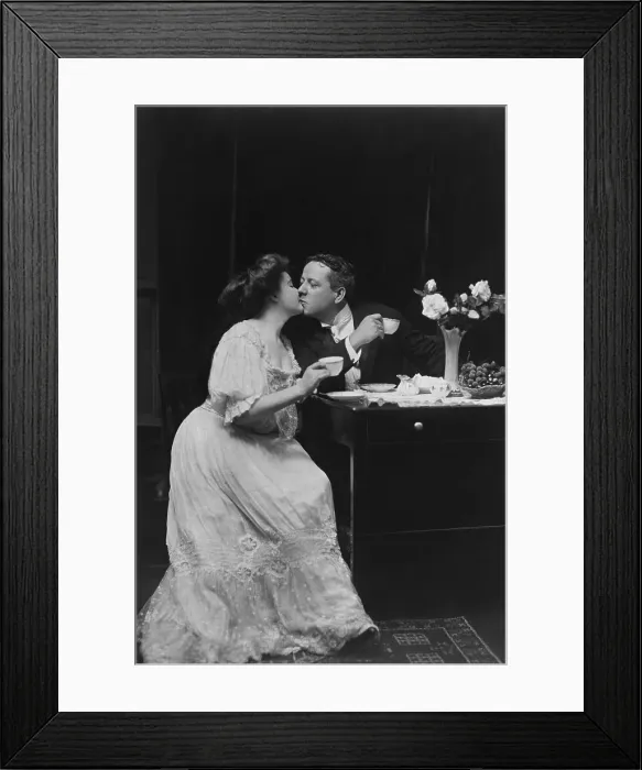 Framed Print : Couple Kissing At Table Framed Print : Couple Kissing At Table