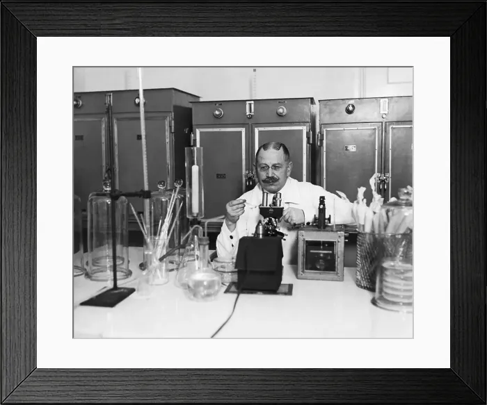 Framed Print : Lab Tech Examining Slide At Microscope Framed Print : Lab Tech Examining Slide At Microscope