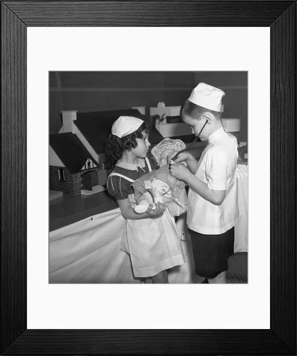 Framed Print : Girl and boy (8-9) pretending to be nurse and doctor Framed Print : Girl and boy (8-9) pretending to be nurse and doctor