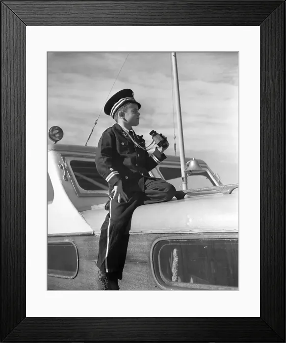 Framed Print : Vintage photograph showing boy (8-9) in naval uniform sitting on yacht deck Framed Print : Vintage photograph showing boy (8-9) in naval uniform sitting on yacht deck