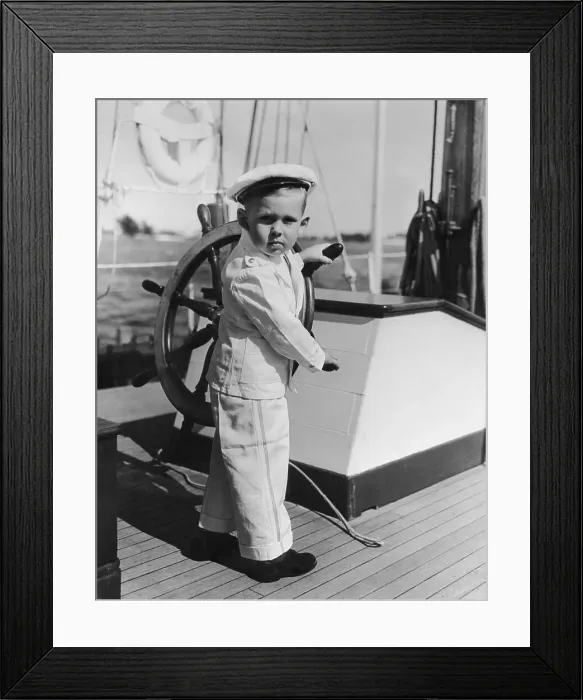 Framed Print : Boy (4-5) playing with yacht helm Framed Print : Boy (4-5) playing with yacht helm