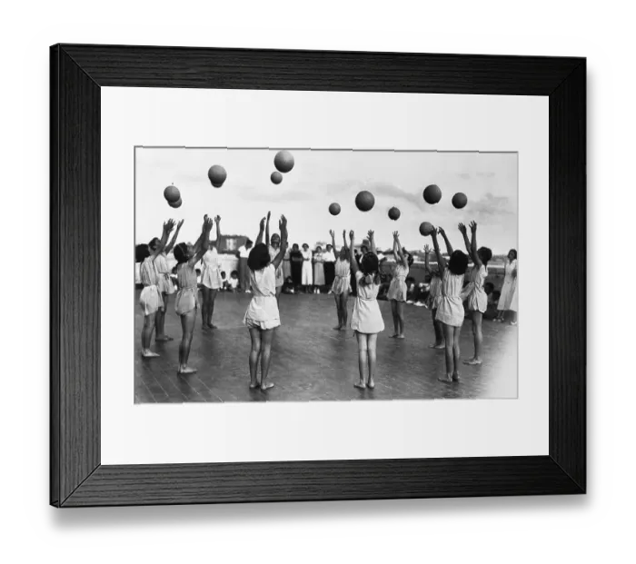 Framed Print : Group of girls (8-9) throwing up balls Framed Print : Group of girls (8-9) throwing up balls