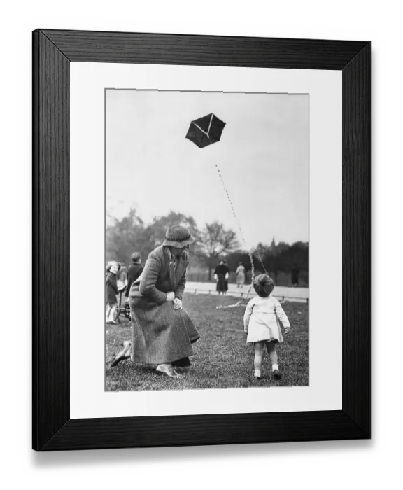 Framed Print : Grandmother with toddler girl (2-3) playing with kite Framed Print : Grandmother with toddler girl (2-3) playing with kite