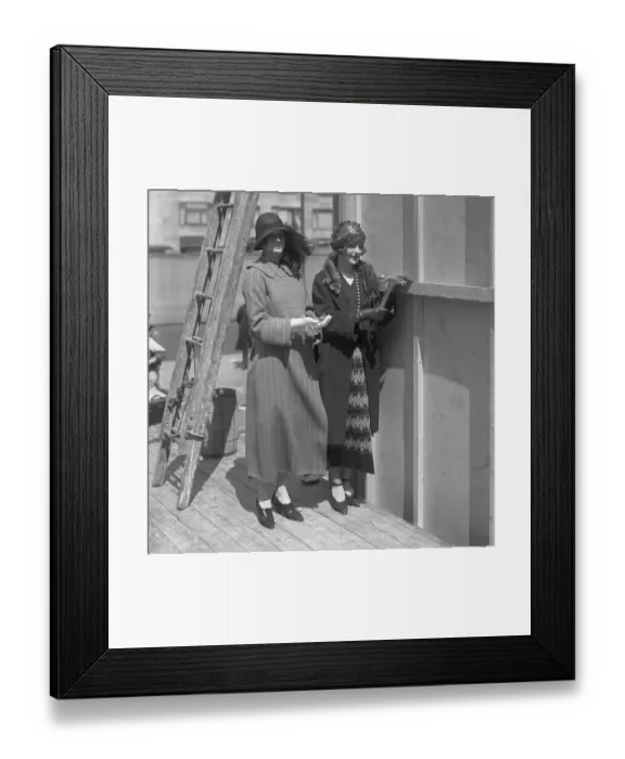 Framed Print : Two young women standing in construction site
