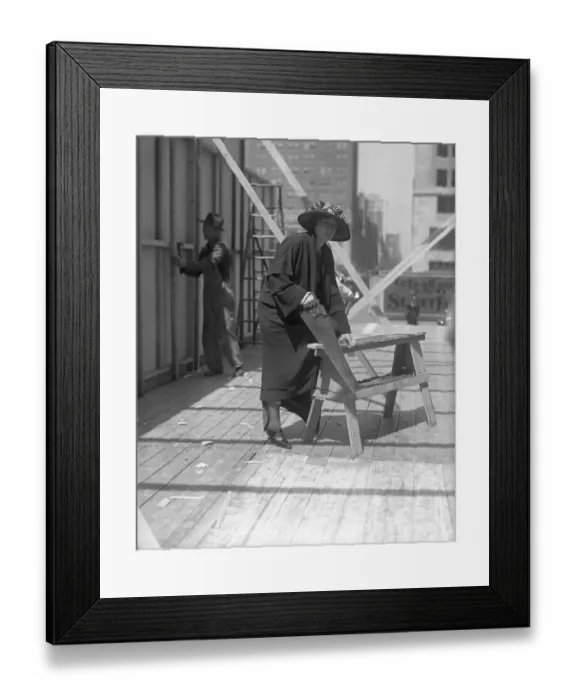 Framed Print : Young woman sawing plank Framed Print : Young woman sawing plank