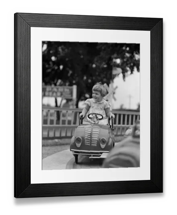 Framed Print : Vintage photograph showing girl (4-5) riding in carousel Framed Print : Vintage photograph showing girl (4-5) riding in carousel