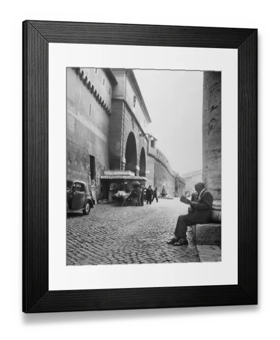 Framed Print : Man Reading Newspaper by Cobblestone Street Framed Print : Man Reading Newspaper by Cobblestone Street