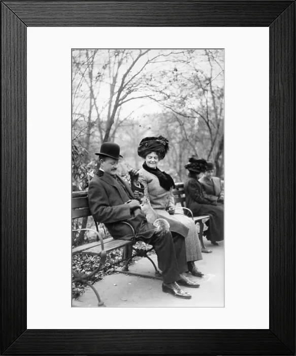 Framed Print : Couple Feeding Squirrel in Park Framed Print : Couple Feeding Squirrel in Park