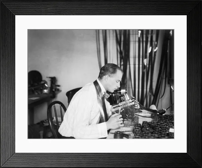 Framed Print : Man Editing Film; Editing Machine Framed Print : Man Editing Film; Editing Machine