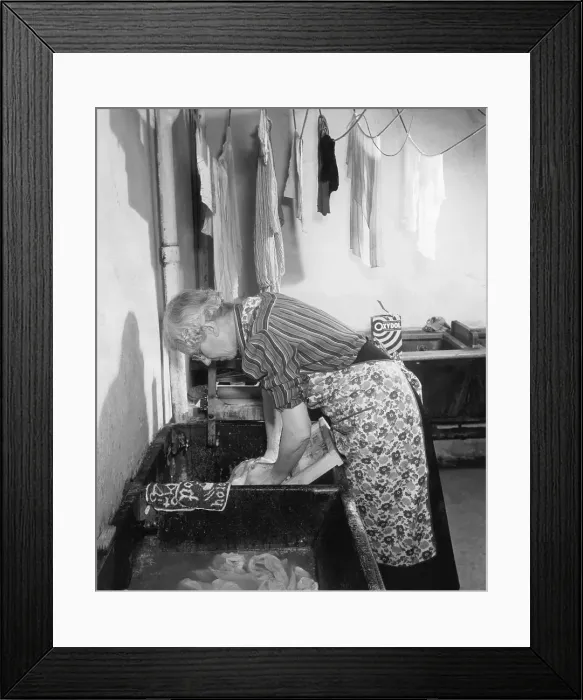 Framed Print : Elderly Woman Washing Clothes On Board Framed Print : Elderly Woman Washing Clothes On Board