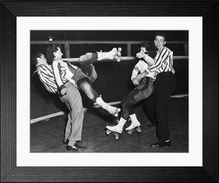 Framed Print : Men Restraining Women Roller Skaters Framed Print : Men Restraining Women Roller Skaters