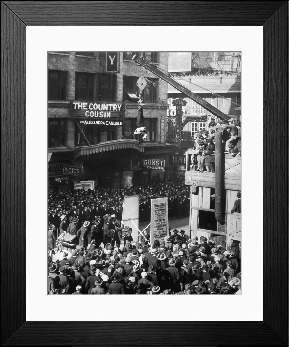 Framed Print : Harry Houdini Slips Straitjacket While Upside Down over Street Framed Print : Harry Houdini Slips Straitjacket While Upside Down over Street