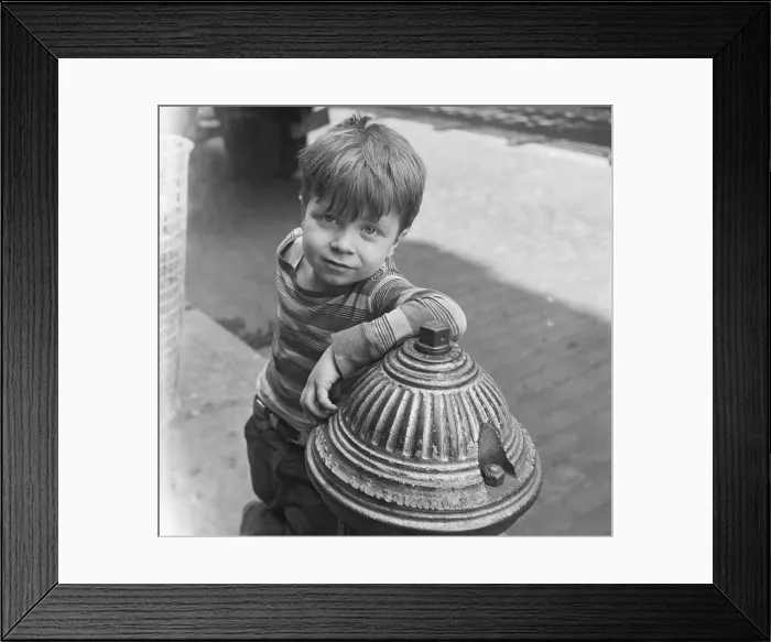 Framed Print : Boy Leans Nonchalantly On Fire Hydrant