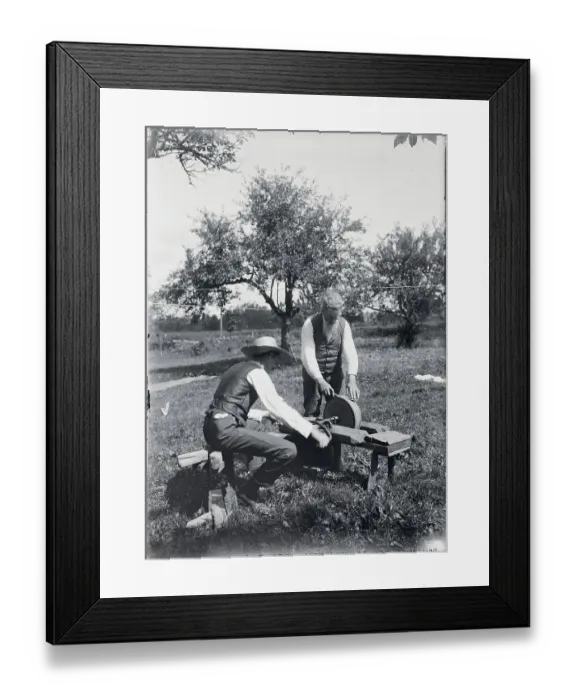 Framed Print : Two Men Working with Early Grindstone Framed Print : Two Men Working with Early Grindstone