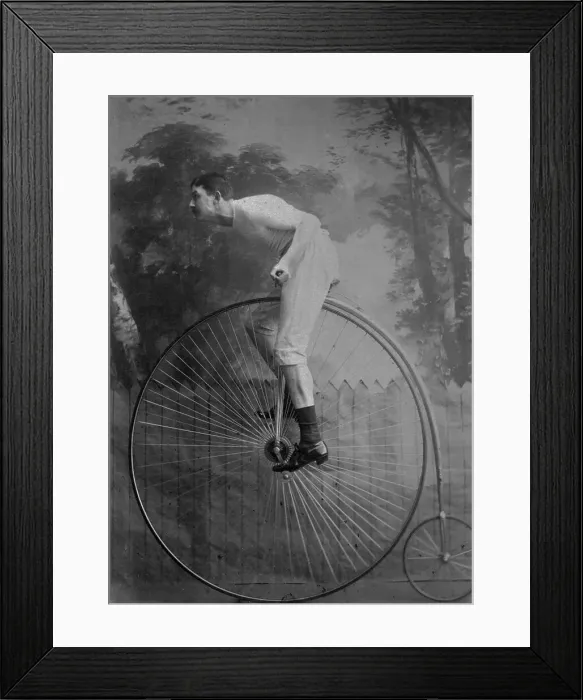 Framed Print : Man Riding Penny-Farthing Bicycle Framed Print : Man Riding Penny-Farthing Bicycle