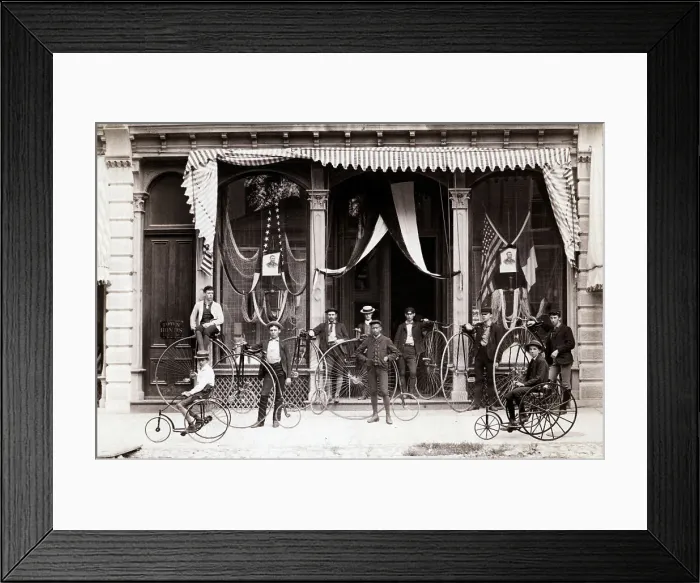 Framed Print : Bicyclists Posed In Front Of Draped Buil Framed Print : Bicyclists Posed In Front Of Draped Buil