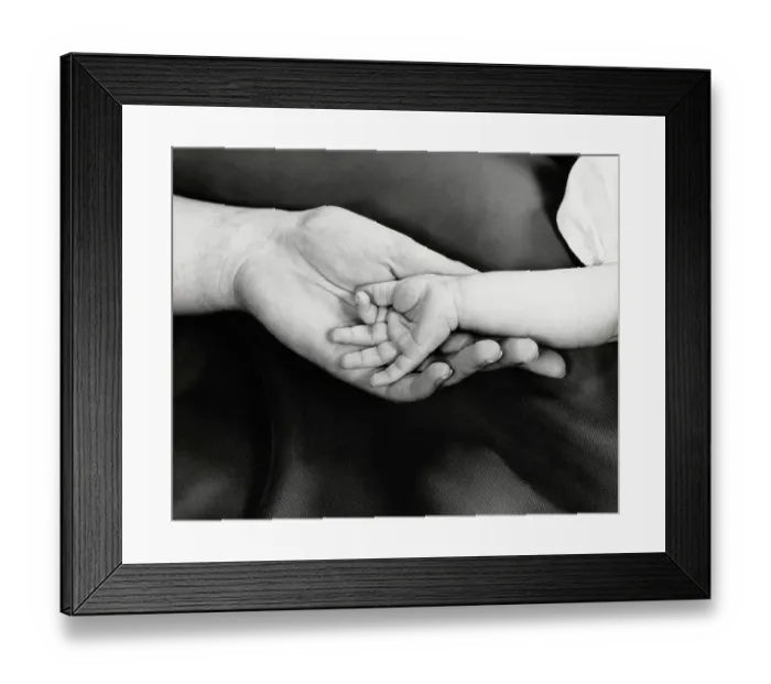 Framed Print : Baby girl's hand in mother's hand, close-up Framed Print : Baby girl's hand in mother's hand, close-up