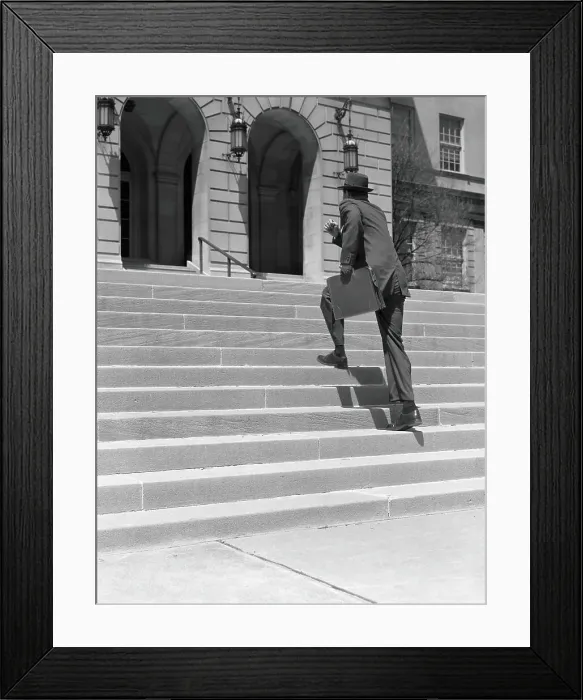 Framed Print : Man wearing suit, running up stairs with briefcase in hand, low section Framed Print : Man wearing suit, running up stairs with briefcase in hand, low section