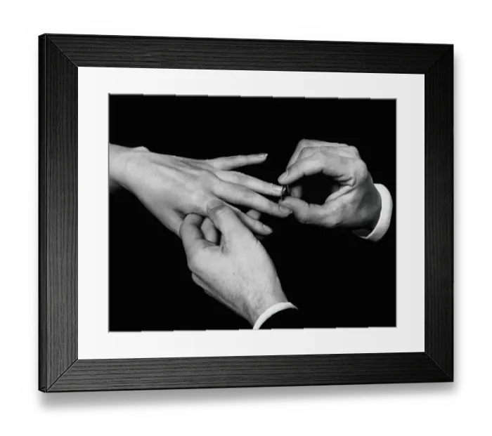 Framed Print : Man's hand putting ring on woman's finger Framed Print : Man's hand putting ring on woman's finger