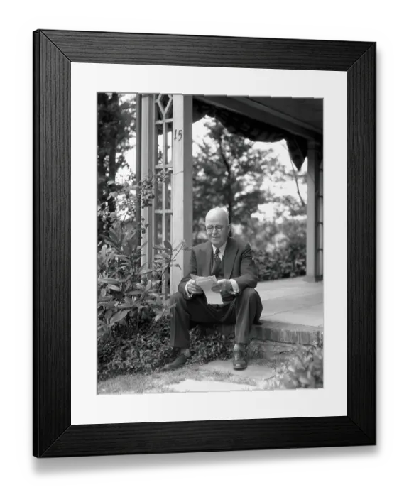 Framed Print : Elderly man, smiling, sitting on front porch step, reading letter