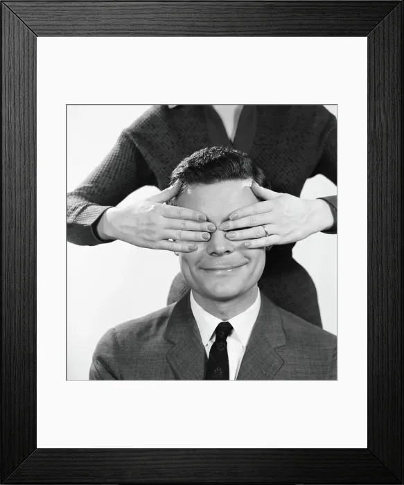 Framed Print : Woman using hands to cover eyes of smiling man Framed Print : Woman using hands to cover eyes of smiling man
