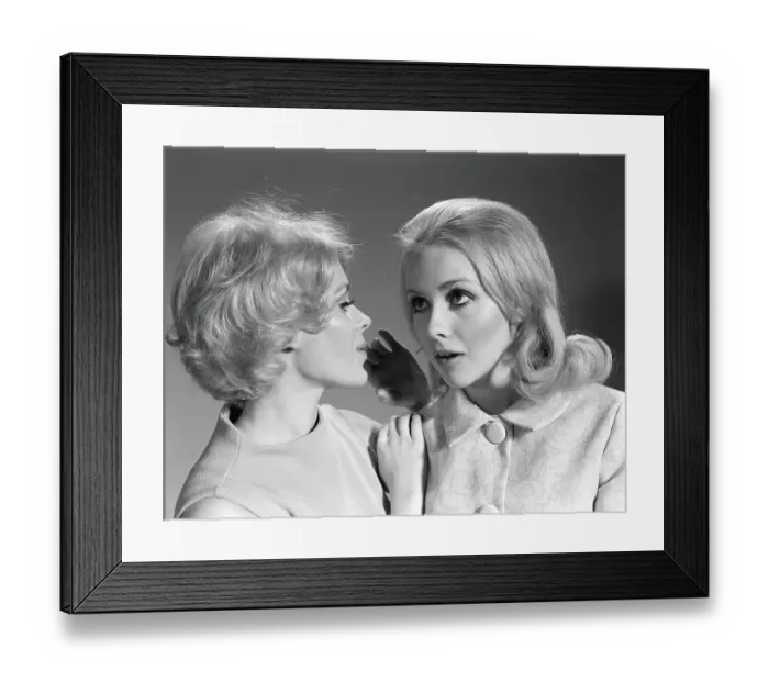 Framed Print : Woman whispering secret into another woman's ear Framed Print : Woman whispering secret into another woman's ear