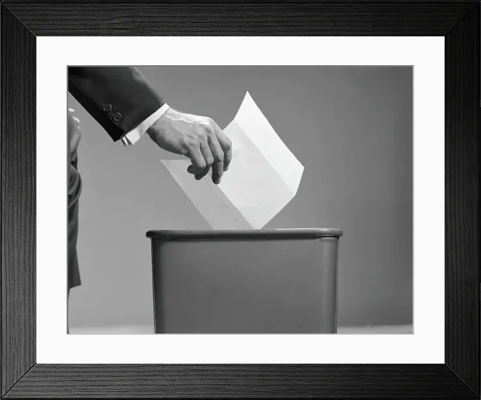Framed Print : Man's hand tossing paper into trash can Framed Print : Man's hand tossing paper into trash can