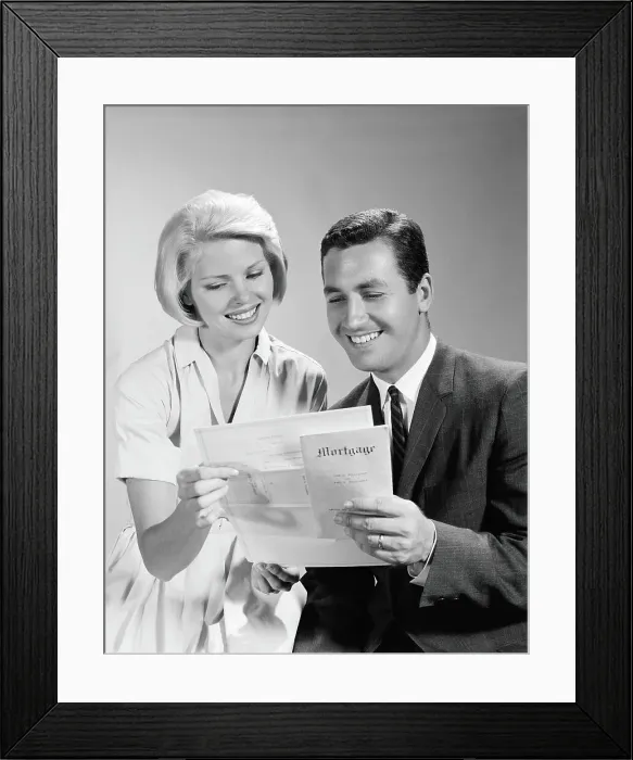 Framed Print : Husband and wife homeowners looking at mortgage and smiling