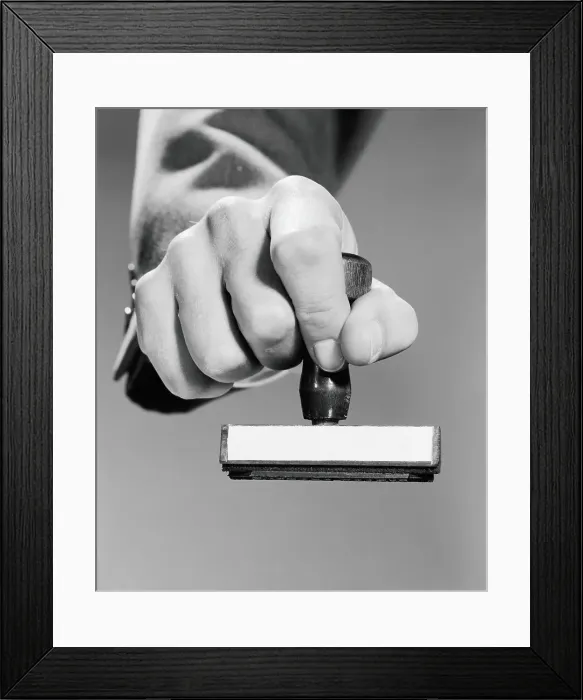 Framed Print : Man's hand holding rubber stamp, poised about to stamp Framed Print : Man's hand holding rubber stamp, poised about to stamp