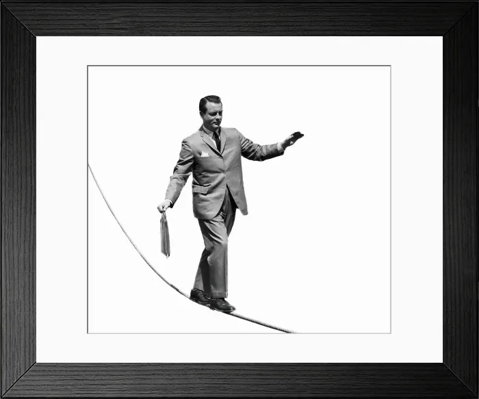 Framed Print : Salesman with briefcase walking tightrope Framed Print : Salesman with briefcase walking tightrope