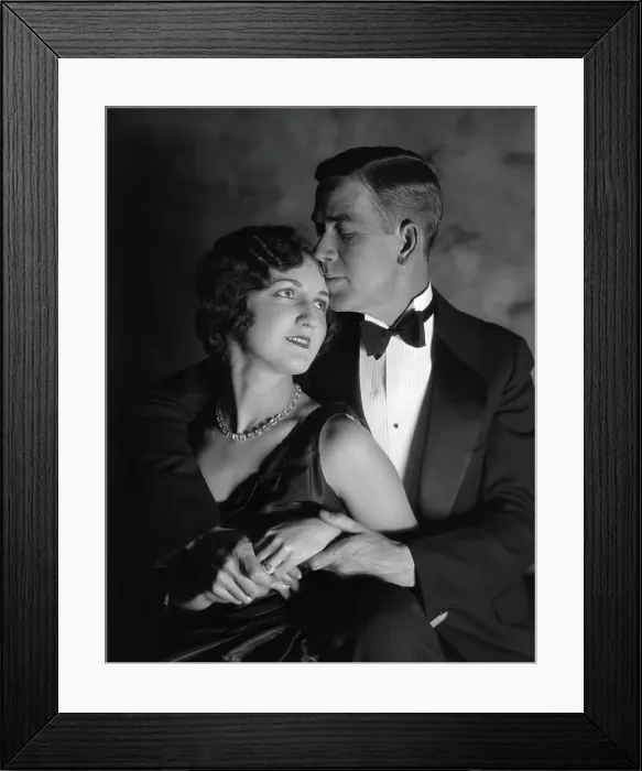 Framed Print : Couple in evening wear, embracing, woman looking up at man, man kissing woman's forehead Framed Print : Couple in evening wear, embracing, woman looking up at man, man kissing woman's forehead