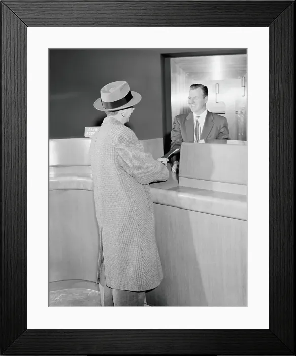 Framed Print : Man talking to teller in bank, vault in background Framed Print : Man talking to teller in bank, vault in background