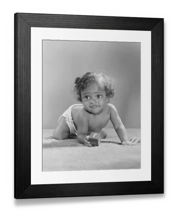 Framed Print : 14 month old African-American baby holding alphabet block, crawling, close-up Framed Print : 14 month old African-American baby holding alphabet block, crawling, close-up