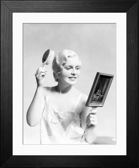 Framed Print : Beautiful woman wearing slip, looking in mirror and brushing hair Framed Print : Beautiful woman wearing slip, looking in mirror and brushing hair