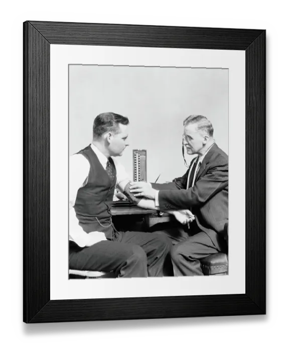 Framed Print : Male doctor taking blood pressure of male patient Framed Print : Male doctor taking blood pressure of male patient
