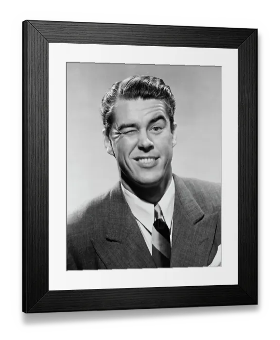Framed Print : Wink Wink. A businessman winks dramatically, circa 1950