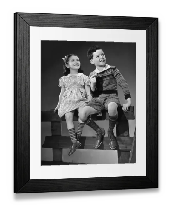 Framed Print : Girl and boy sitting on fence Framed Print : Girl and boy sitting on fence