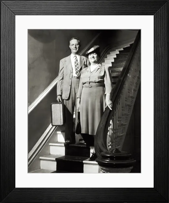 Framed Print : MIDDLE-AGED COUPLE WITH SUITCASE STANDING ON STAIRCASE