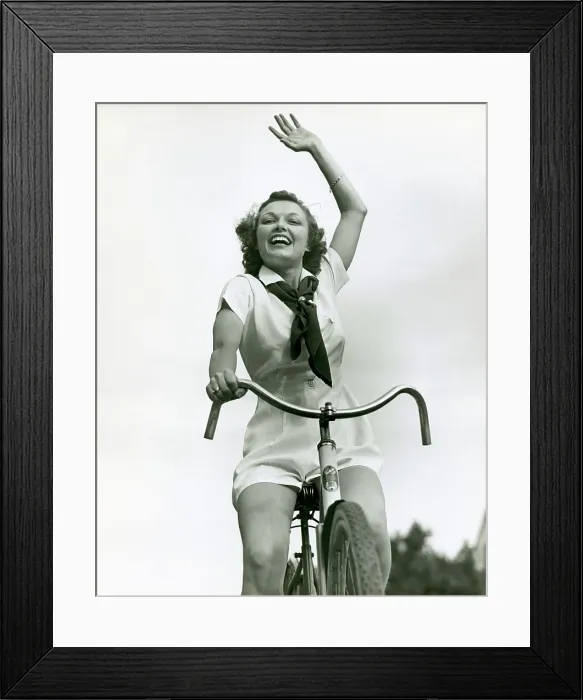Framed Print : Girl on bike, waving Framed Print : Girl on bike, waving