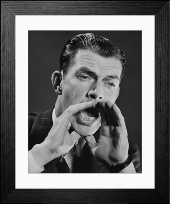 Framed Print : Hey There. A man cups his hands around his mouth to shout, circa 1950 Framed Print : Hey There. A man cups his hands around his mouth to shout, circa 1950