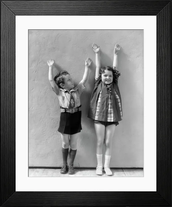 Framed Print : Boy & Girl Standing Next To One Another With Arms Raised Above There Heads Girl Is Wearing A Panel Dress And White Socks & Shoes Boy Shirt Tie Shorts Framed Print : Boy & Girl Standing Next To One Another With Arms Raised Above There Heads Girl Is Wearing A Panel Dress And White Socks & Shoes Boy Shirt Tie Shorts